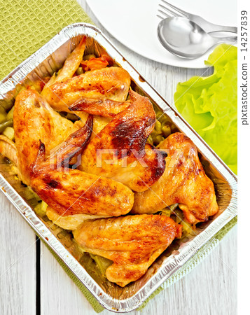Chicken wings fried with vegetables in pan from foil Chicken wings fried with vegetables in pan from foil 14257839