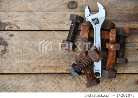 Old bolts with adjustable wrench tools on wooden background. Old bolts with adjustable wrench tools on wooden background. 14261075