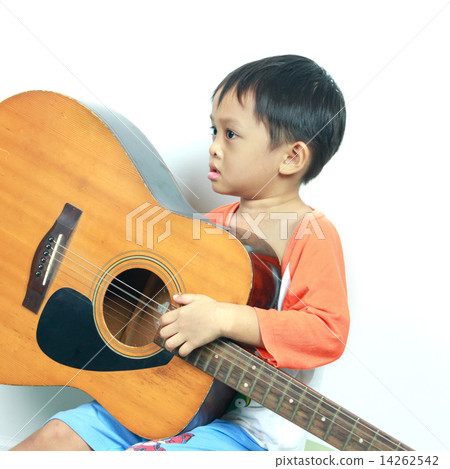 Little boy playing acoustic guitar Little boy playing acoustic guitar 14262542