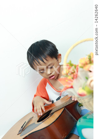 Little boy playing acoustic guitar Little boy playing acoustic guitar 14262640