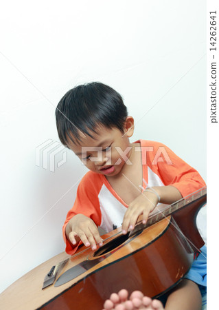 Little boy playing acoustic guitar Little boy playing acoustic guitar 14262641