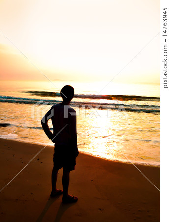 silhouette of man alone and wave on the beach 14263945