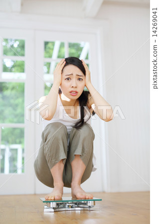 A young woman riding a scale 14269041