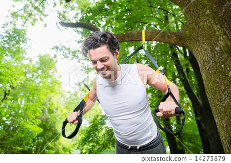 man doing suspension trainer sling sport 14275879