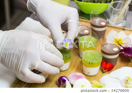 cook prepares canapes dessert edible flowers and buds 14278609