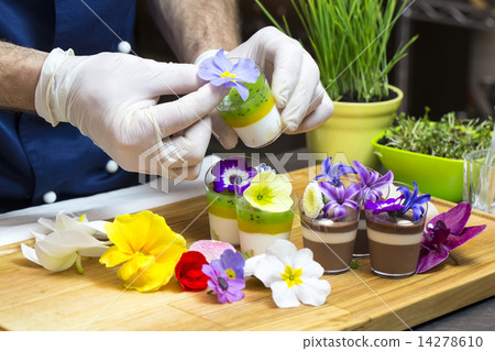cook prepares canapes dessert edible flowers and buds 14278610