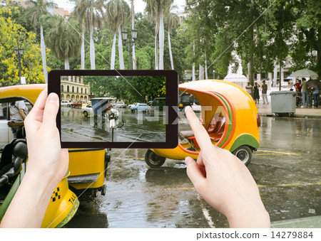 tourist taking photo of Havana street in rain tourist taking photo of Havana street in rain 14279884