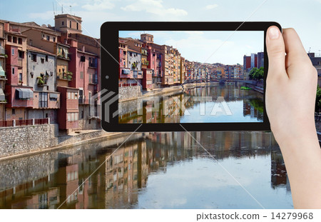tourist taking photo of river in Girona town 14279968