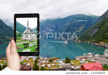 tourist taking photo of geiranger village 14280085