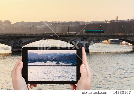 tourist taking photo of bridge in Paris on sunset 14280107
