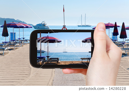 tourist taking photo of sand beach Giardini Naxos tourist taking photo of sand beach Giardini Naxos 14280228