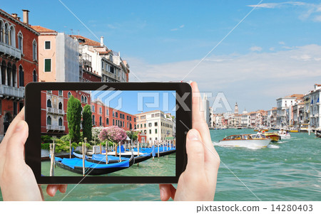 tourist taking photo of parking of gondolas 14280403