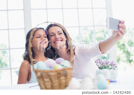 Happy mother and daughter taking selfie 14282480