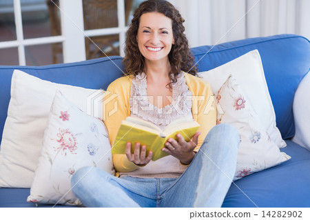 Pretty brunette relaxing on the couch Pretty brunette relaxing on the couch 14282902
