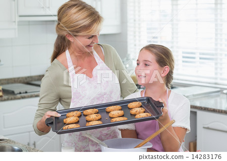 Mother and daughter making cookies together Mother and daughter making cookies together 14283176