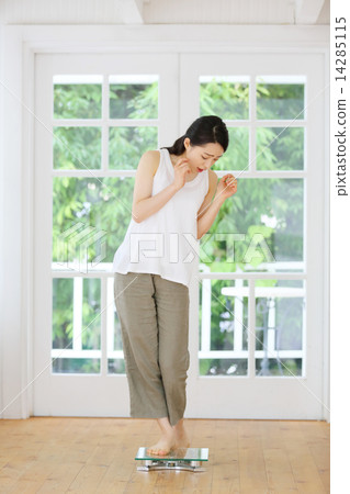A young woman riding a scale A young woman riding a scale 14285115