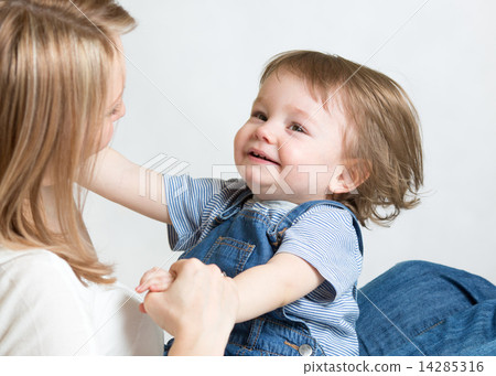 Mom and kid having fun pastime. Parenthood happiness conception. 14285316