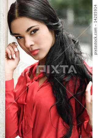 Hispanic stewardess in urban background 14285914
