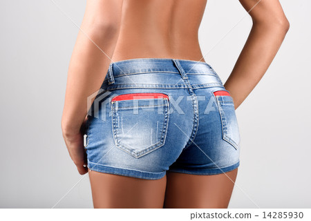 Woman wearing denim shorts with a beautiful waist Woman wearing denim shorts with a beautiful waist 14285930