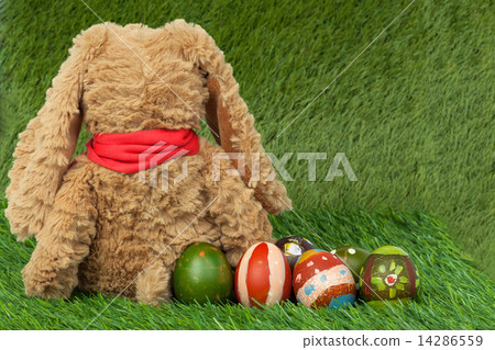 Rabbit, sit on green grass and group of colorful eggs are behind Rabbit, sit on green grass and group of colorful eggs are behind 14286559