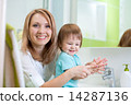 Happy mother and child washing hands with soap in bathroom 14287136