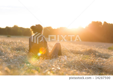 Girl sitting on meadow Girl sitting on meadow 14287500