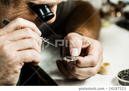 Clockmaker repairing wrist watch 14287523