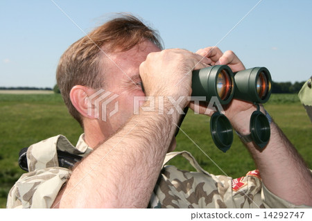 Male field officer watching through binocular 14292747