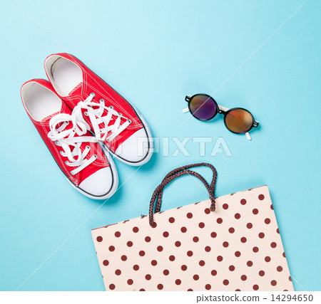 Red gumshoes with shpping bags and sunglasses 14294650