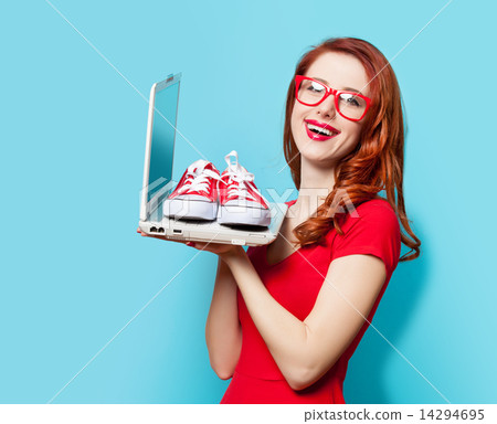 Style redhead girl with gumshoes and laptop 14294695