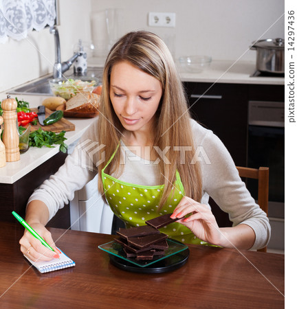 Woman weighing chocolate 14297436