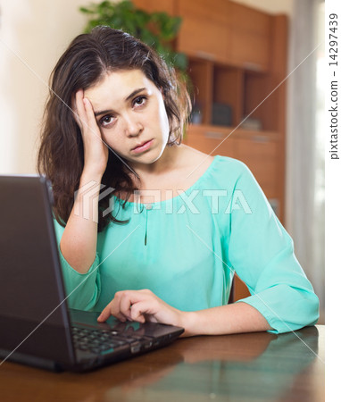 Sad woman with laptop 14297439