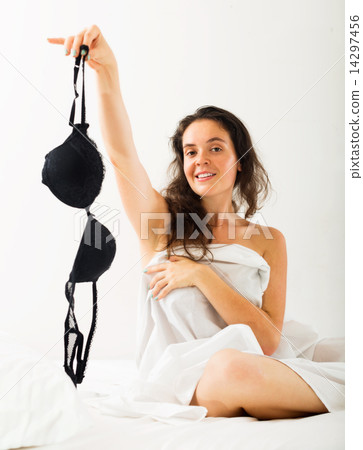 Girl takes off underwear on bed 14297456