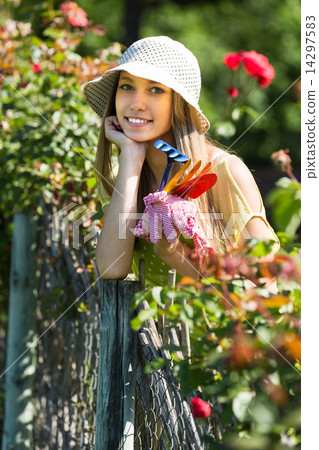 Female florist in the garden Female florist in the garden 14297583