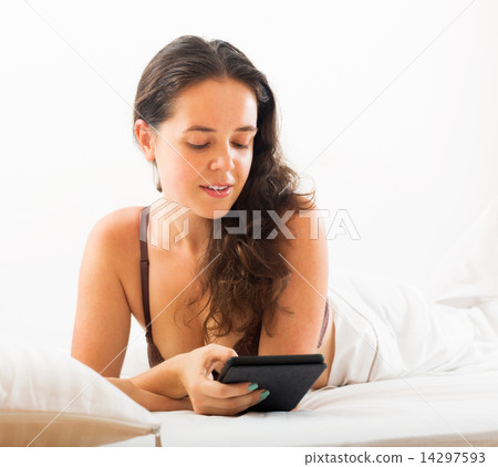 Woman with tablet in bed 14297593