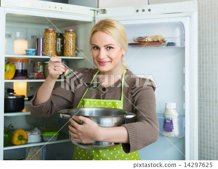 Girl eating soup from pan 14297625
