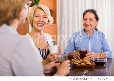 Three women drinking tea 14297689