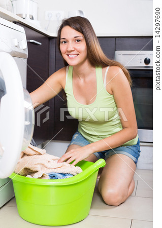 Woman using washing machine 14297690
