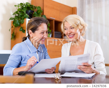 senior ladies signing documents 14297836