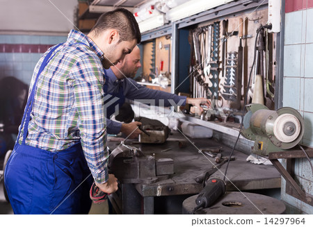 Men at work in repair shop 14297964