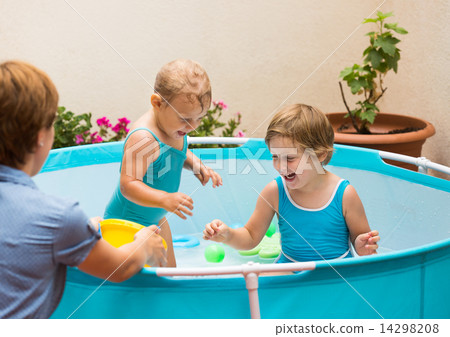 Children and mother playing with balls in pool Children and mother playing with balls in pool 14298208
