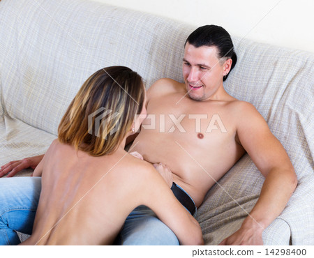 girl seducing handsome man on sofa 14298400