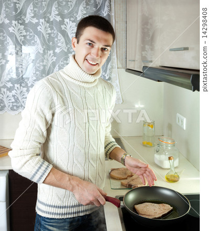 man frying steak of fish 14298408