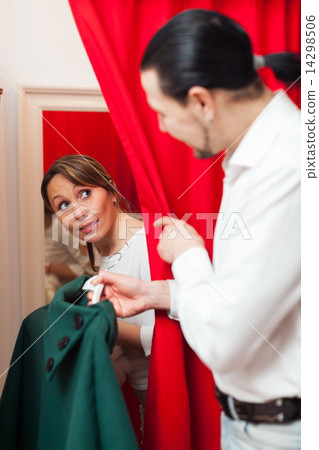 Adult couple trying coat Adult couple trying coat 14298506