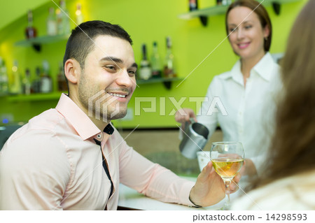 Female barista and two clients in cafe 14298593