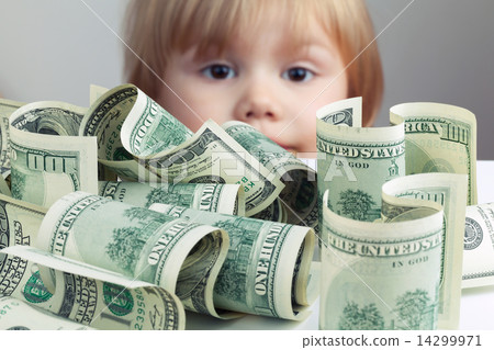 Pile of United States dollars and baby on a background Pile of United States dollars and baby on a background 14299971
