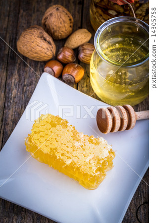 honey dipper and honeycomb, nuts of various kinds 14305758