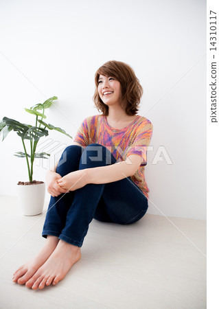 smile, smiling, sitting on the floor with arms around knees 14310117