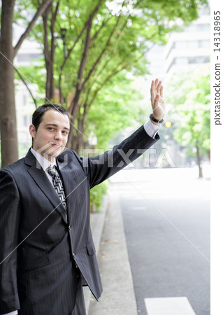 Foreign businessman calling a taxi Foreign businessman calling a taxi 14318965