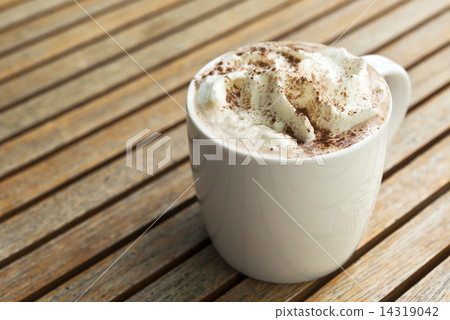 Cup of hot Chocolate topping with whipping cream and cocoa powde 14319042